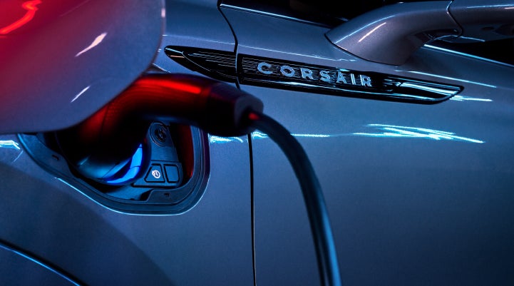 A charger plugged into the charging port of a 2024 Lincoln Corsair® Plug-in Hybrid model. | Capital Lincoln of Wilmington in Wilmington NC