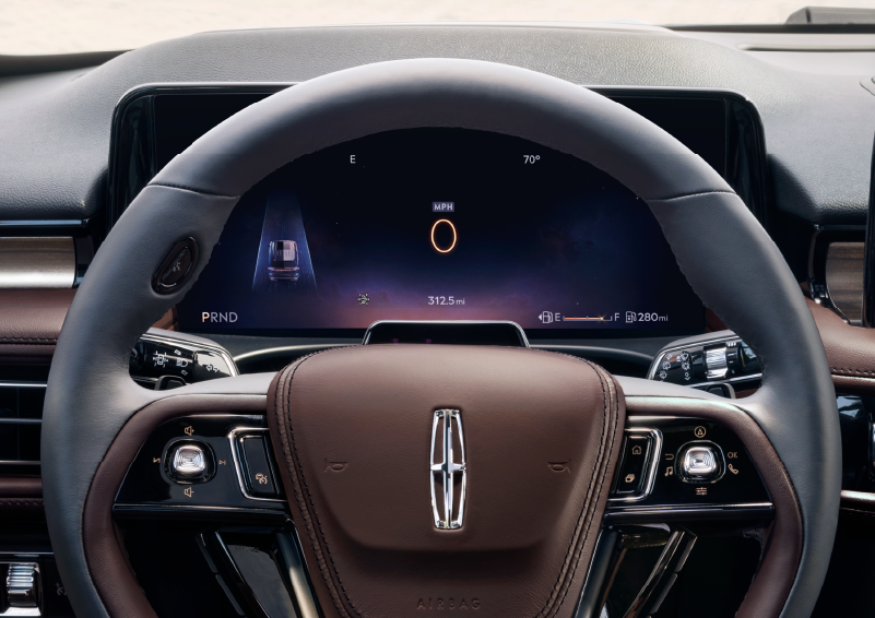 The steering wheel of 2025 Lincoln Aviator® SUV is shown with black and brown accents. | Capital Lincoln of Wilmington in Wilmington NC