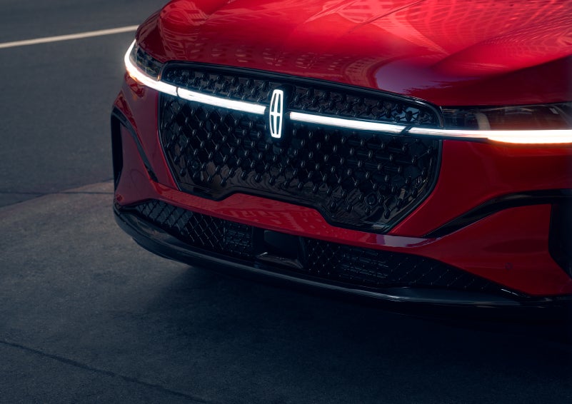 The available front LED light bar and center Lincoln Star logo glow at dusk. | Capital Lincoln of Wilmington in Wilmington NC