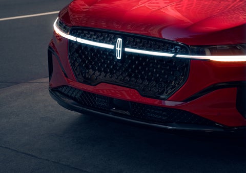 The available front LED light bar and center Lincoln Star logo glow at dusk. | Capital Lincoln of Wilmington in Wilmington NC