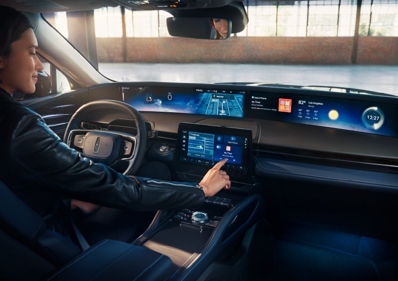 The driver of a 2025 Lincoln Nautilus® SUV interacts with the center touchscreen. | Capital Lincoln of Wilmington in Wilmington NC