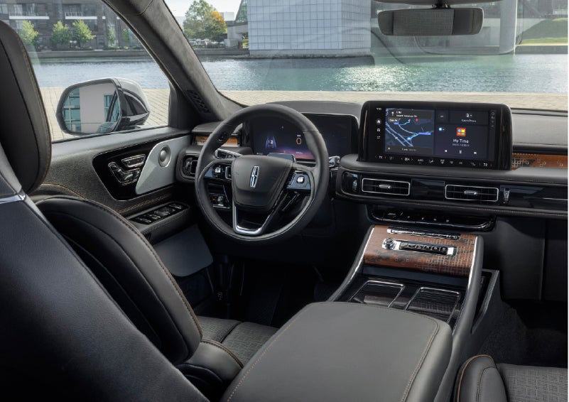 The interior of the 2026 Lincoln Aviator® SUV is shown parked with a view of a harbor through the windshield. | Capital Lincoln of Wilmington in Wilmington NC