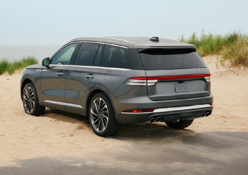 A 2027 Lincoln Aviator® SUV is parked next to sand dunes. | Capital Lincoln of Wilmington in Wilmington NC