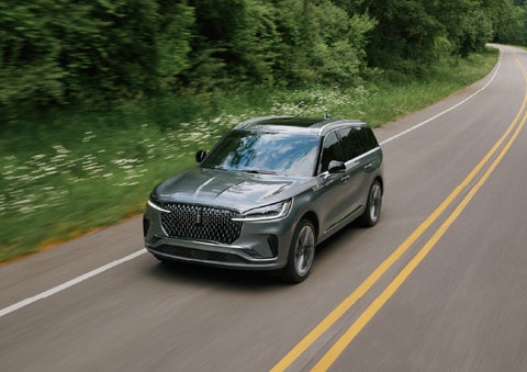 A 2027 Lincoln Aviator® SUV is being driven down a road. | Capital Lincoln of Wilmington in Wilmington NC