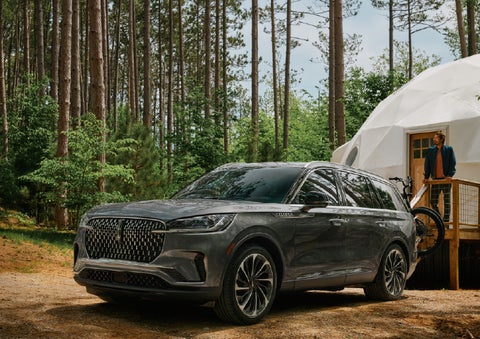 A 2027 Lincoln Aviator® is parked next to a high end glamping site. | Capital Lincoln of Wilmington in Wilmington NC