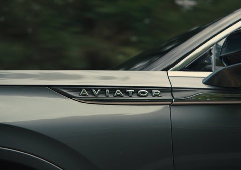 The driver’s side door and fender badging of a gray 2027 Lincoln Aviator® SUV are showcased. | Capital Lincoln of Wilmington in Wilmington NC