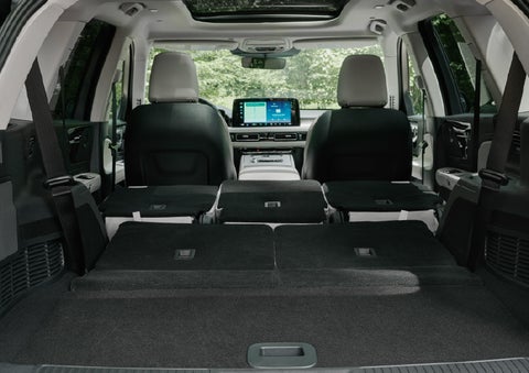 A rear to front view of the interior of a 2027 Lincoln Aviator® Black Label™ SUV shows the third and second rows folded flat | Capital Lincoln of Wilmington in Wilmington NC