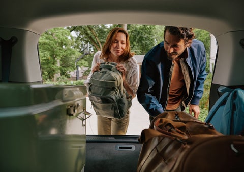 A couple loads luggage into the rear of a 2027 Lincoln Aviator® Black Label™ SUV..e 202 | Capital Lincoln of Wilmington in Wilmington NC