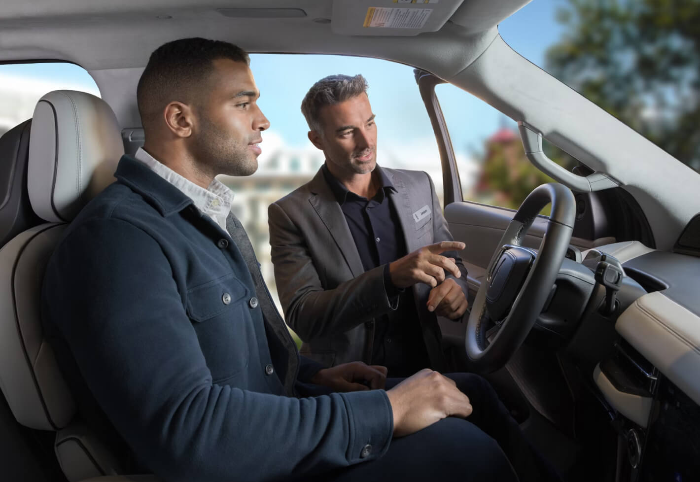 Lincoln Salesman Guiding Customer To Lincoln Interior Features