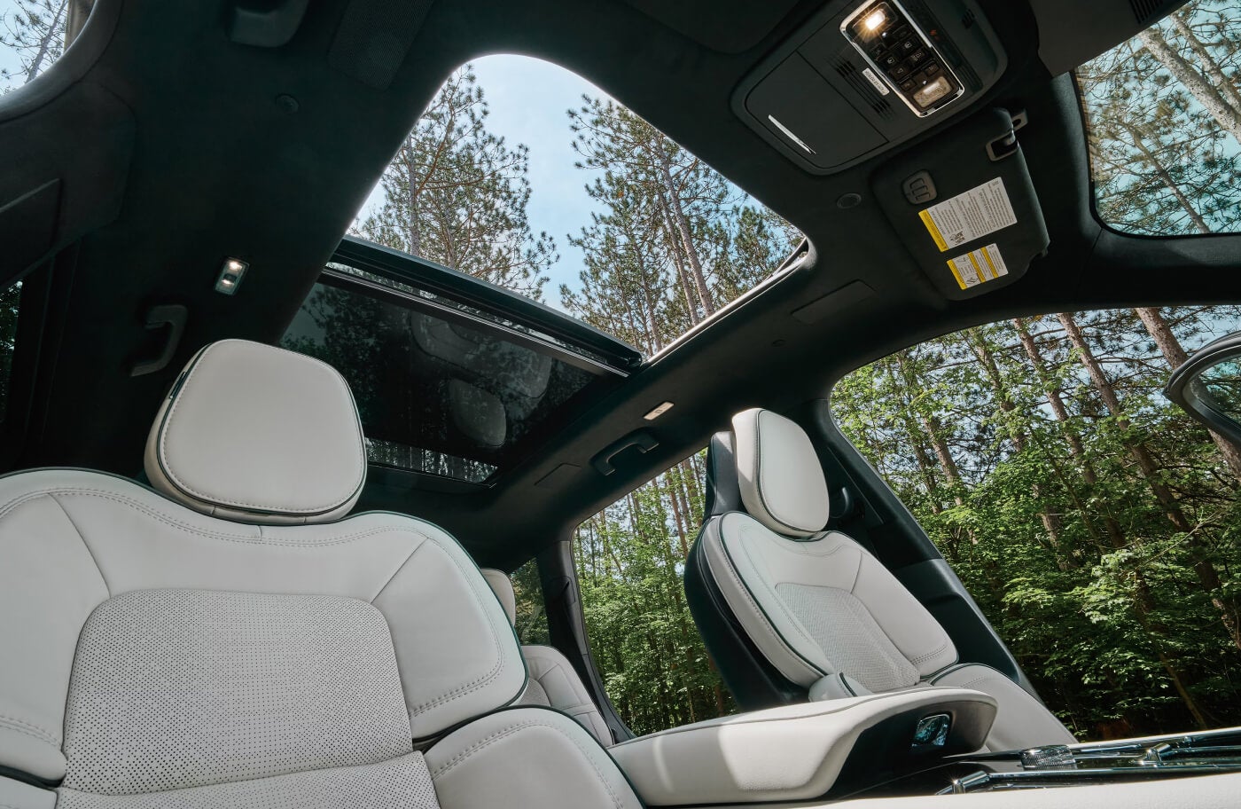 Interior low angle shot showing the 2027 Lincoln Aviator headroom, panoramic sunroof and premium leather upholstery.