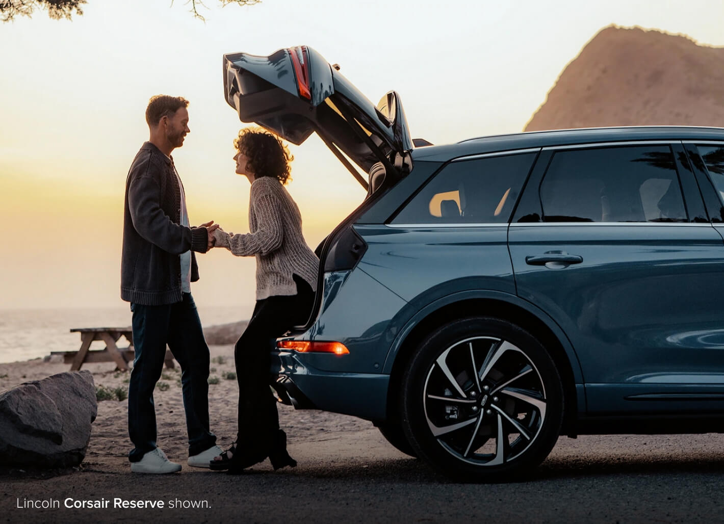 Couple holding hands in the behind Lincoln Corsair Reserve