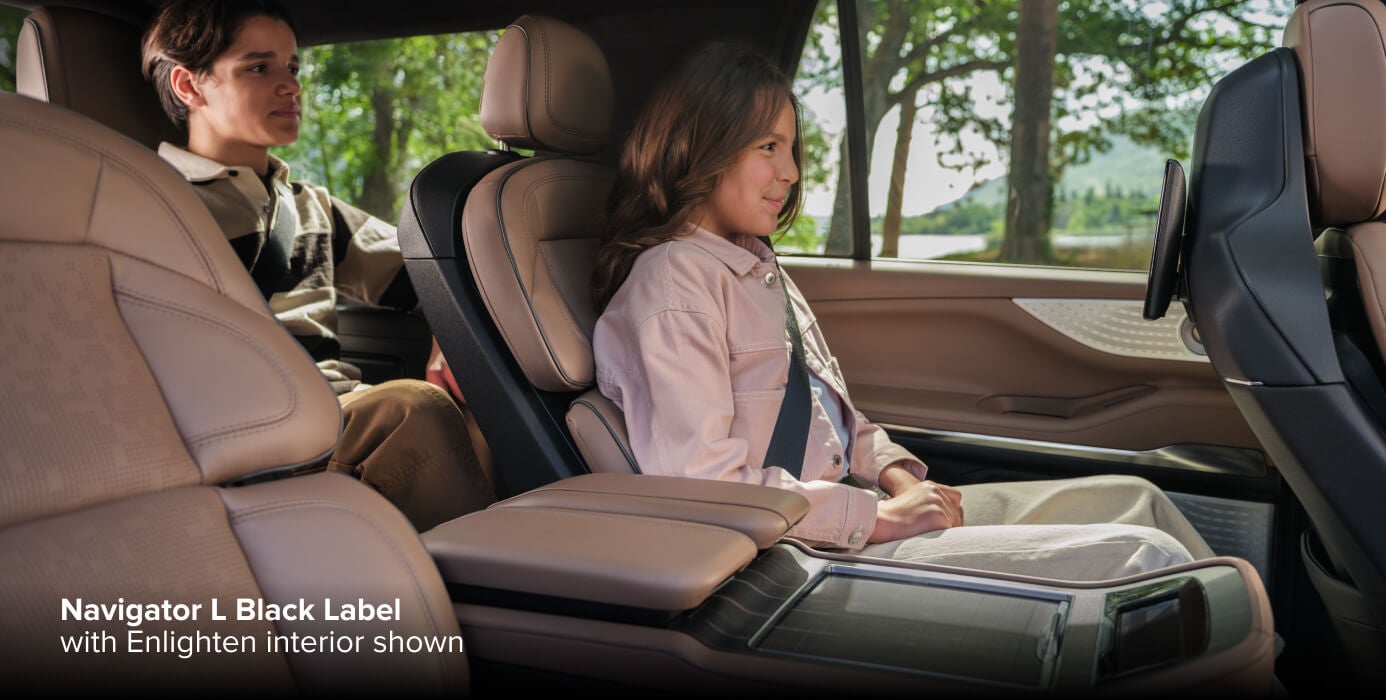 2027 Lincoln Navigator L Black Label with Enlighten interior, second-row back view with two passengers seated in second and third row.